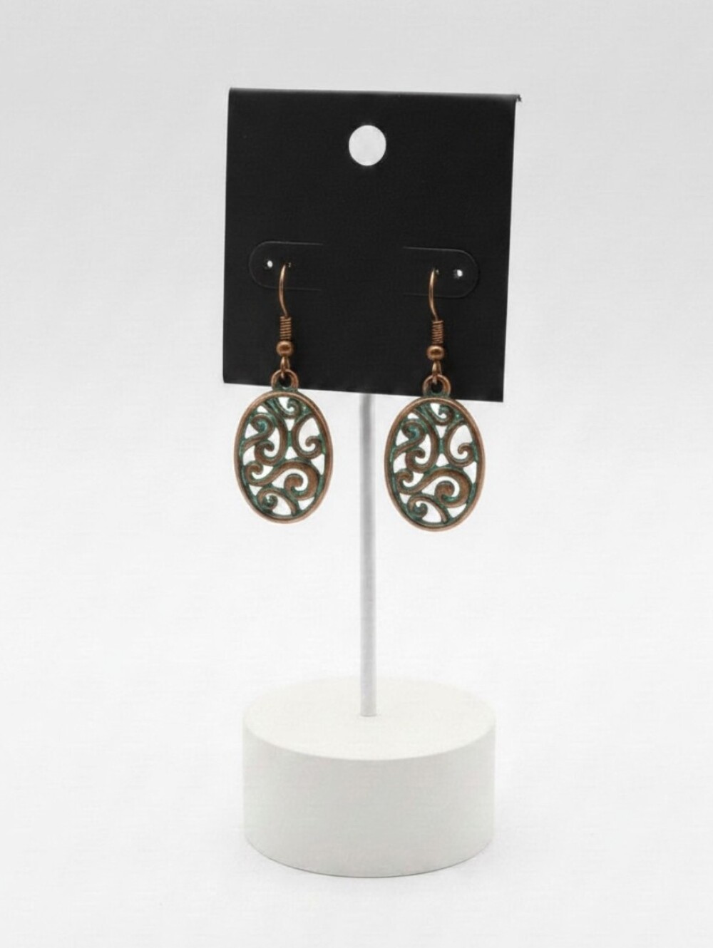 Aged Copper Oval Earrings with Intricate Design